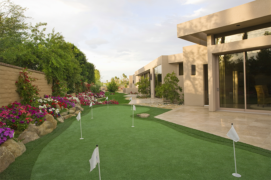 Modern home with a lush garden and mini putting green.